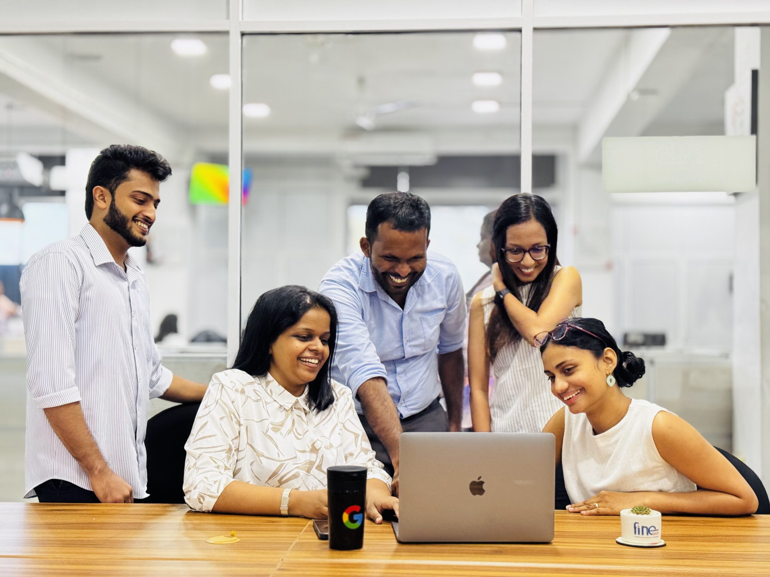 A team of people collaborating and working together at a table in an office